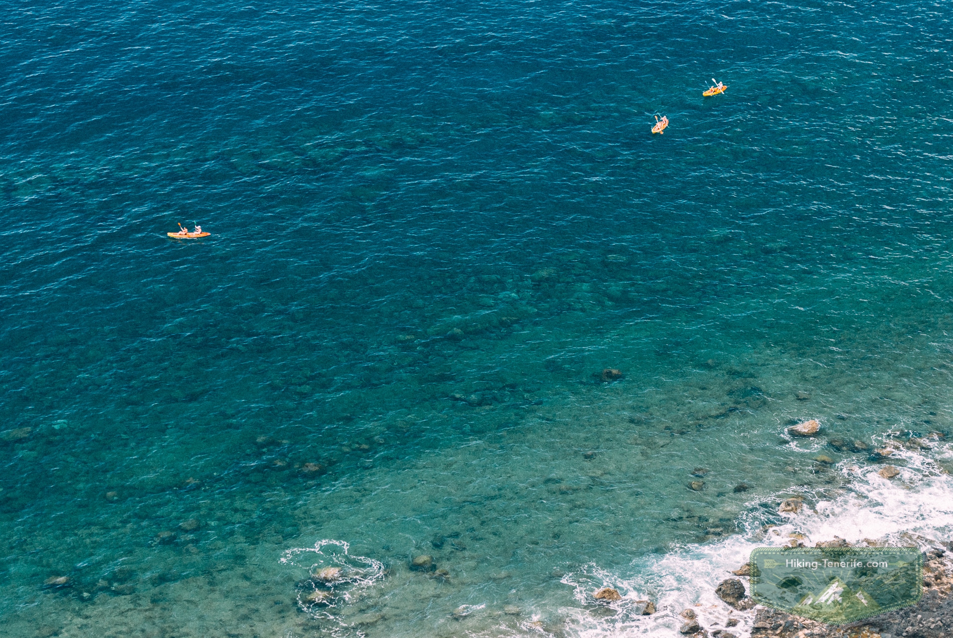 Kayaks on clear water near the Los Gigantes coast