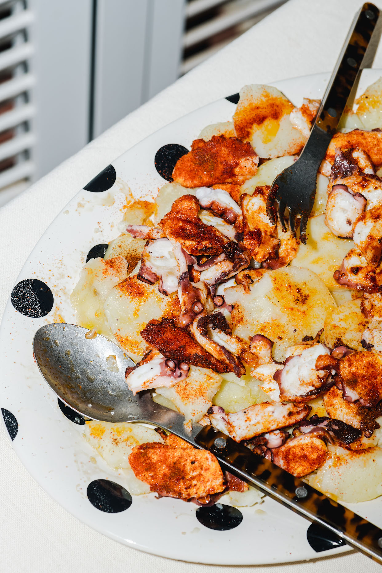 Tender cooked octopus pieces ready for the hot finishing stage