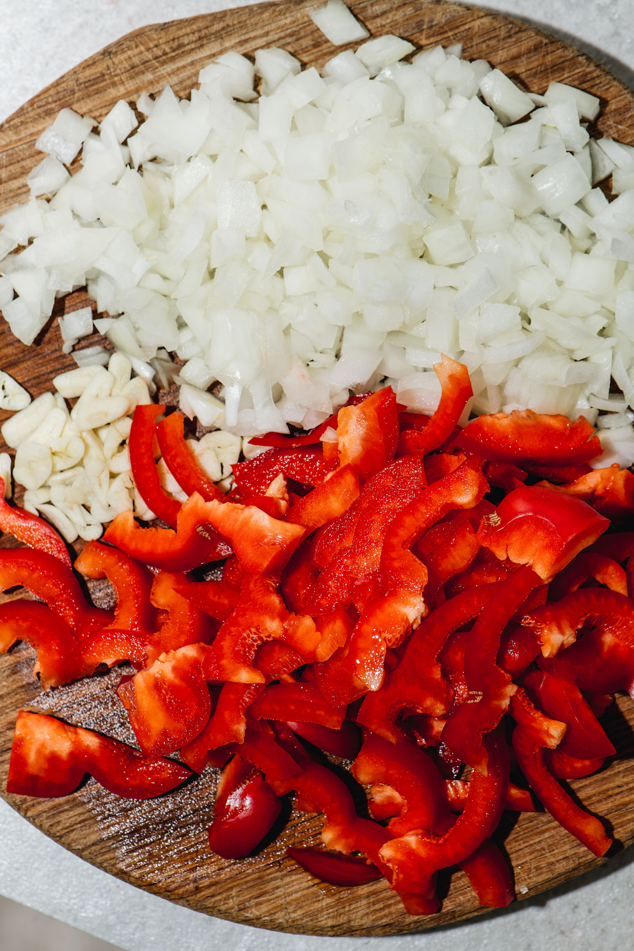 Chopped onion garlic and red pepper prepared for seafood paella